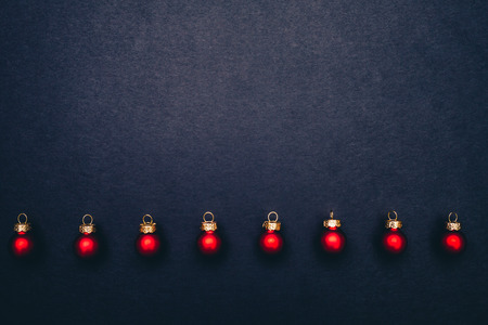 Christmas red shiny balls flat layout on dark background. Top closeup view with copy space.の写真素材