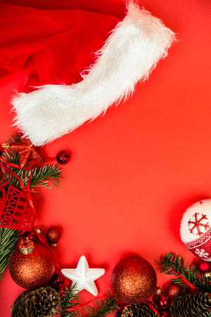 Christmas gift or present over red holidays background with fir tree and red christmas balls. Top view with copy space for textの写真素材