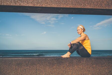 Woman meditating in yoga pose, ocean view. Motivation and inspirational summer sea landscape. Healthy lifestyle outdoors in nature concept.の写真素材