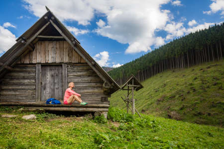 Young woman hiker camping and resting in beautiful Tatra mountains on hiking trip in shelter. Inspirational landscape in Poland. Active girl resting outdoors in summer nature.の写真素材