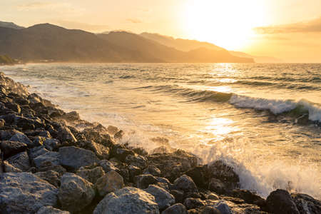 Inspirational beautiful mountains landscape with sea, coast, beach and rocks, high mountains in background at sunrise on Crete Island, Greece.の写真素材