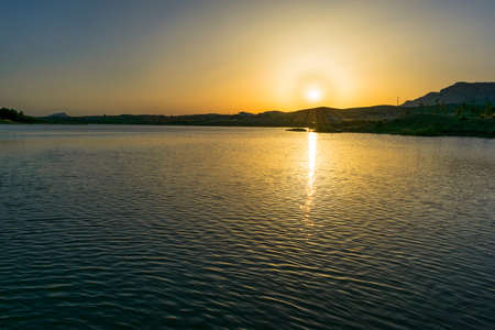 In the image can see a fantastic sunset reflected in the waterの写真素材