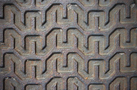 Metal linear pattern on the surface of the manhole lid detail の写真素材