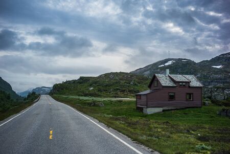 Old house in Norway and dramatic skyの写真素材