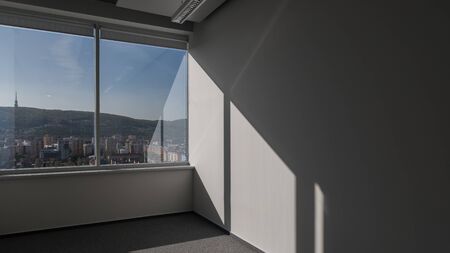 empty office with white walls and panoramic view windowの写真素材