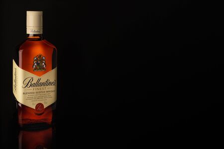 bottle of finest blended scotch whiskey on black background with reflection on glassのeditorial素材