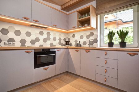 gray kitchen in a wooden apartment in the mountainsの写真素材