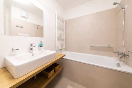 she had a bathroom with a bathtub, a mirror and a large sink
