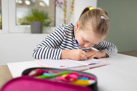 biased student doing homework in workbook, pretty girl with blond hair