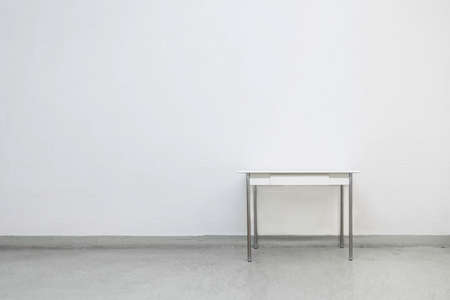 Isolated table against white wallの写真素材