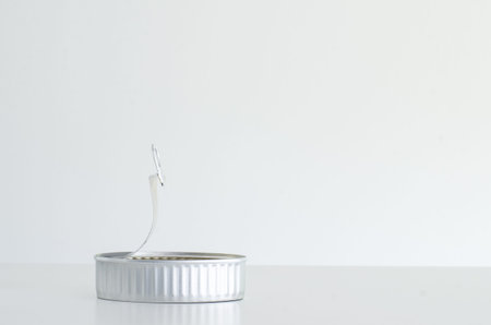 Generic opened bright tin aluminum aluminium can isolated against white backdrop