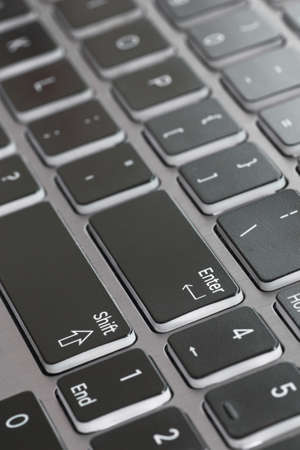 Laptop keyboard macro close up fading enter shift key focusedの写真素材