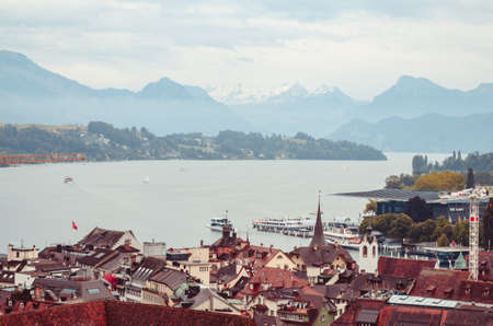 Aerial view of the city of Lucern Switzerland on an overcast day mountains in the backgroundの写真素材