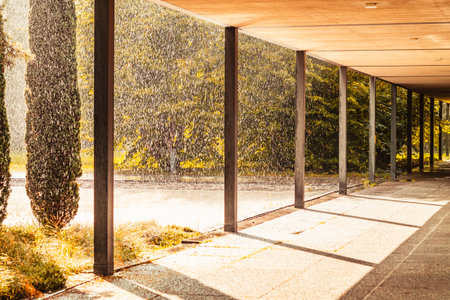 Heavy rain against sun shine in the late evening concrete building passageway point of view 2019