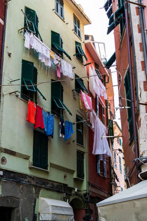 Colourful old buildings with clothing hanging lines in a small town Liguria region ofItaly on a slightly overcast summer dayy 2019の写真素材