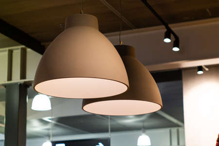 Indoor bar light fixtures  round grey hanging from the ceiling low angle view  2020の写真素材