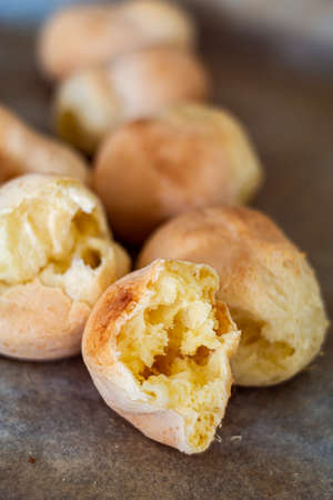 Pao di queijo small cheese breads fresh out of the oven front piece opened up shallow depth of field warm light 2020の写真素材