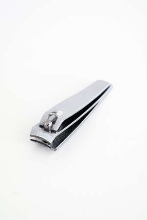 Single metal silver nail clipper macro close up shot isolated against white 2020の写真素材