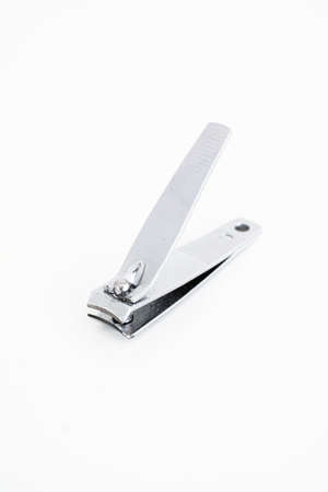 Single metal silver nail clipper macro close up shot isolated against white 2020の写真素材
