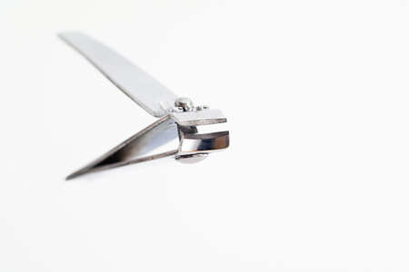Single metal silver nail clipper macro close up shot isolated against white 2020の写真素材