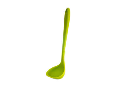 Single silicone green small plastic ladle close up shot isolated on pure white 2020の写真素材
