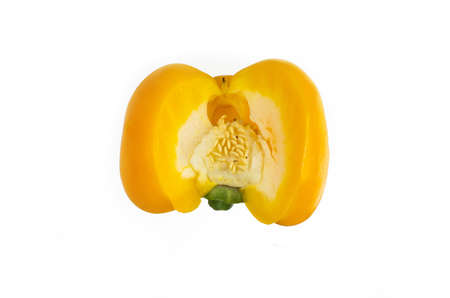 Single half sliced yellow pepper with core and seeds close up macro shot isolated on white 2020の写真素材