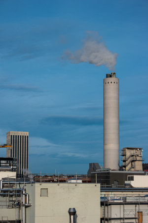 High vantage point view of industrial area of Zurich city Switzerland concrete smoking chimney in...