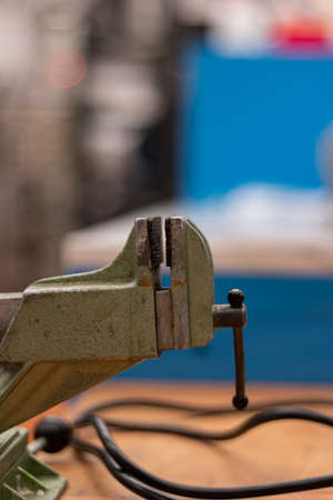 Small vintage cast iron vise in a science workshop shallow depth of field 2020の写真素材