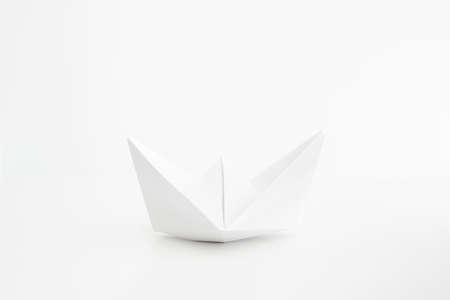 White folded paper boat frontal shot isolated on bright background 2020の写真素材