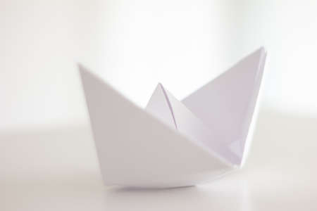 White folded paper boat side view isolated on bright background shallow depth of field 2020の写真素材