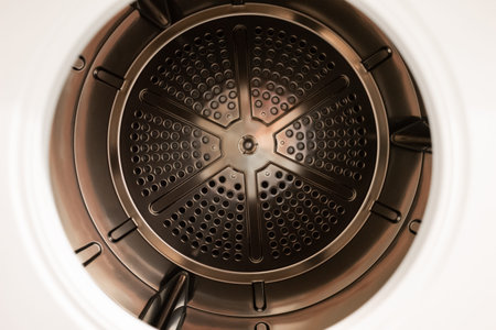 Open door bronze metal empty tumbler dryer close up shot 2020