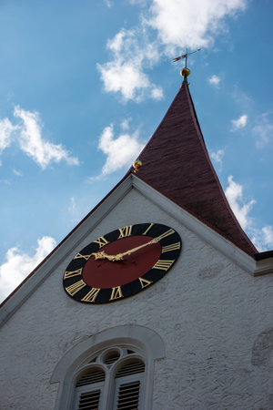 Small town rural Reformed Christian Church bell tower and analog clock close up shot from below...