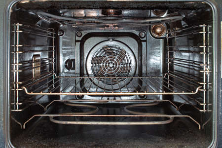 Inside view of a used open dirty stained oven and grilled metal tray 2020の写真素材