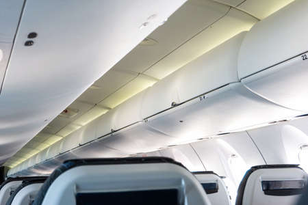 Airplane cabin overhead luggage bins closed no people 2020の写真素材