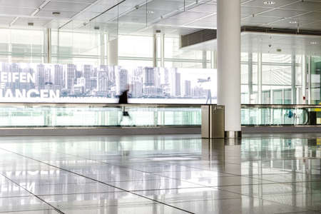 Munich international airport terminal waiting lounge with rolling road and blurry travelers 2020の写真素材