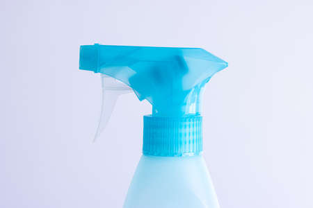 Light blue trigger atomizer bottle close up shot isolated on bright background.の写真素材