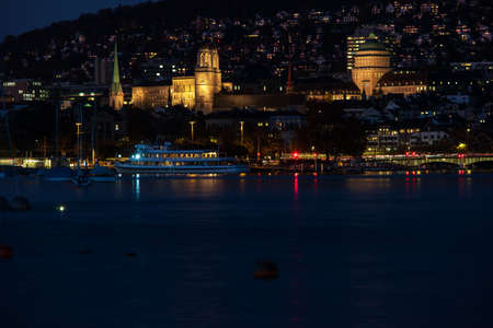Zurich city Switzerland late evening blue hour hills in the background lake side view.の写真素材