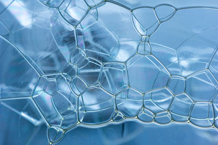 Abstract rectangular shaped soap bubbles in plastic bottle macro close up front view.