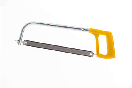 Small manual wood saw with yellow plastic handle close up isolated on white.の写真素材