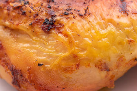 Golden crispy roasted chicken legs with skin macro close up shot .の写真素材