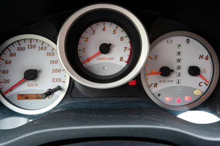Generic analog car gauges on white background close up shot.