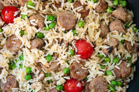 Eastern rice sausage peas and cherry tomatoes dish top view close up macro shot.の写真素材