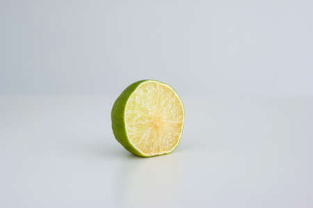 Fresh green halved lime close up shot isolated on white.の写真素材