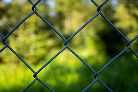 Chain link wire fence close up shot, shallow depth of field.の写真素材
