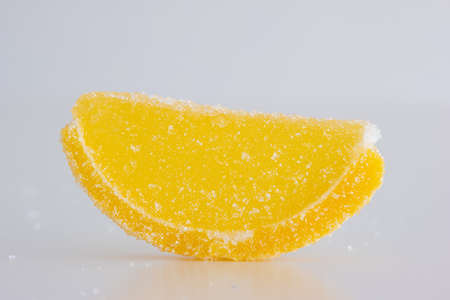 Vibrant sliced candied citrus fruits macro close up shot. Isolated on white, no people.の写真素材