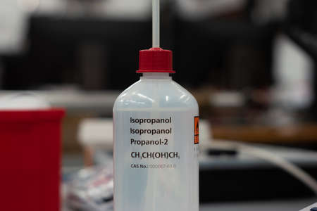 Isopropanol plastic bottle and dispenser. Close up shot in a science lab. Shallow depth of field, no people.の写真素材