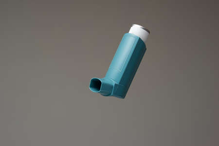 Asthma inhaler, generic, non-branded. Close up studio shot, isolated on gray background.の写真素材