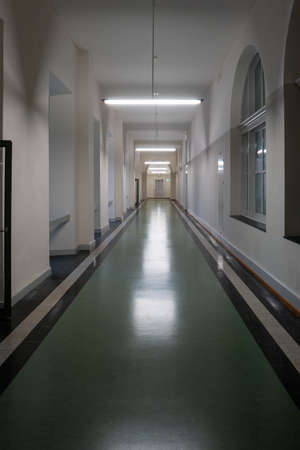 ETH University Zurich, Switzerland. Interior long illuminated hallway corridor with beautiful architecture, stone arches and polls, no people..の写真素材