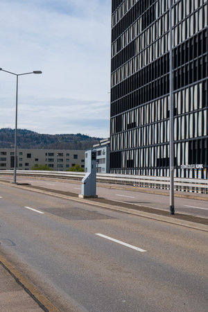 Road traffic speed trap camera in a gray box between 4 lanes of road in a major European city. No traffic, no people.の写真素材