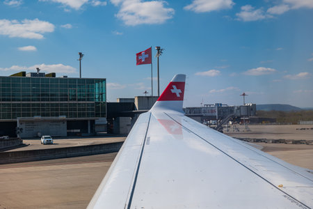 Commercial airplane wing of Swiss air company, grounded on Zurich airport on 04/09/2023. No people.のeditorial素材